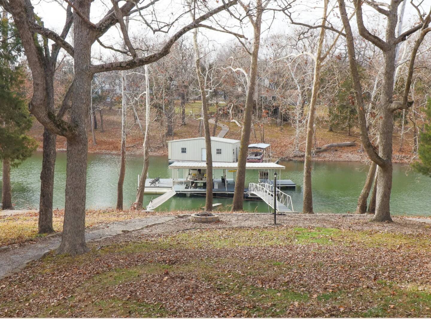 View of shared dock from house, 1 boat slip included w/ house